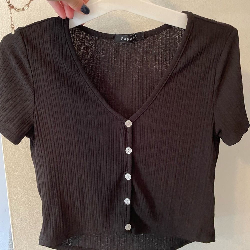 Basic black shirt with white buttons.